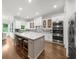 Bright kitchen features a large island with seating, stainless steel appliances, and white cabinetry at 885 Old Peachtree Ne Rd, Lawrenceville, GA 30043
