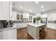 Spacious kitchen featuring stainless steel appliances, tile backsplash, and large central island with stools at 885 Old Peachtree Ne Rd, Lawrenceville, GA 30043