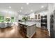 Bright, open kitchen featuring a large island, granite countertops, and stainless steel appliances at 885 Old Peachtree Ne Rd, Lawrenceville, GA 30043