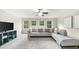 Bright living area with plush gray sofa, neutral walls, and ample natural light from multiple windows at 885 Old Peachtree Ne Rd, Lawrenceville, GA 30043