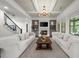 Bright living room with fireplace, built-ins, modern lighting, and staircase access at 885 Old Peachtree Ne Rd, Lawrenceville, GA 30043
