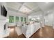 Bright living room with coffered ceiling, hardwood floors, fireplace, and large windows overlooking the landscaped yard at 885 Old Peachtree Ne Rd, Lawrenceville, GA 30043