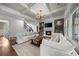 Bright living room with coffered ceiling, fireplace, and built-in shelving showcases modern comfort at 885 Old Peachtree Ne Rd, Lawrenceville, GA 30043