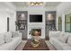 Bright and inviting living room featuring a fireplace flanked by custom shelving, and plush seating at 885 Old Peachtree Ne Rd, Lawrenceville, GA 30043