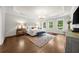 Sunlit main bedroom with hardwood floors, large windows, and a neutral color palette at 885 Old Peachtree Ne Rd, Lawrenceville, GA 30043