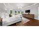 Sun-filled main bedroom with tray ceiling and TV at 885 Old Peachtree Ne Rd, Lawrenceville, GA 30043