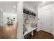 Bright mudroom features built-in bench, storage, and dark hardwood floors, offering stylish organization at 885 Old Peachtree Ne Rd, Lawrenceville, GA 30043