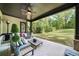 Relaxing covered porch with stylish seating and views of the expansive backyard at 885 Old Peachtree Ne Rd, Lawrenceville, GA 30043