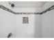 Shower features classic white tile, decorative accent border, and tiled inset shelf at 885 Old Peachtree Ne Rd, Lawrenceville, GA 30043