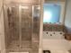 Modern bathroom with glass enclosed shower and jetted tub at 100 Ruby Ln, Mcdonough, GA 30252