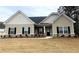 Charming single-story home featuring black shutters and a well-manicured lawn in a quiet neighborhood at 100 Ruby Ln, Mcdonough, GA 30252