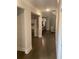 Inviting hallway showcasing hardwood floors and neutral paint leading to the living areas at 100 Ruby Ln, Mcdonough, GA 30252