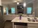 Modern kitchen with stainless steel appliances and granite countertops is open to living room with fireplace at 100 Ruby Ln, Mcdonough, GA 30252