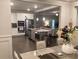 Open-concept kitchen with stainless steel appliances and an island with bar seating at 100 Ruby Ln, Mcdonough, GA 30252