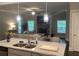 Open concept kitchen with granite countertops, stainless steel appliances and view into living room with fireplace at 100 Ruby Ln, Mcdonough, GA 30252