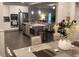 Open-concept kitchen with stainless steel appliances and an island with bar seating at 100 Ruby Ln, Mcdonough, GA 30252
