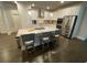 Kitchen island with granite countertop, bar seating, stainless steel appliances and white cabinets at 100 Ruby Ln, Mcdonough, GA 30252