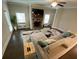 Cozy living room with fireplace, large windows, and hardwood floors at 100 Ruby Ln, Mcdonough, GA 30252