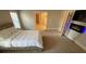 Bedroom with large bed, decorative fireplace and carpeted floors at 100 Ruby Ln, Mcdonough, GA 30252
