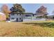 Back exterior of home with covered patio and spacious backyard at 2103 Columbia Dr, Decatur, GA 30032