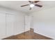 Bright bedroom featuring wood floors, ceiling fan, closet doors, and neutral paint at 2103 Columbia Dr, Decatur, GA 30032