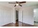 Bedroom with hardwood floors, closet, and doorways to ensuite bath and hallway at 2103 Columbia Dr, Decatur, GA 30032