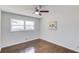 Neutral bedroom featuring a ceiling fan, hardwood floors, and a bright window at 2103 Columbia Dr, Decatur, GA 30032