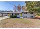Split-level home featuring a charming yellow front door and a well-maintained lawn with mature trees at 2103 Columbia Dr, Decatur, GA 30032