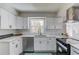 This updated kitchen features white cabinets, quartz countertops, and stainless steel appliances at 2103 Columbia Dr, Decatur, GA 30032