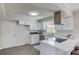 Modern kitchen with white cabinets, stainless steel appliances, and a breakfast bar at 2103 Columbia Dr, Decatur, GA 30032