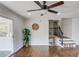 Bright living room features hardwood floors, ceiling fan, and access to a staircase at 2103 Columbia Dr, Decatur, GA 30032