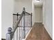 Staircase features decorative wrought iron spindles, stained wooden handrail and hardwood floors at 2103 Columbia Dr, Decatur, GA 30032