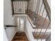 Stairway featuring wood steps, metal railing, and access to the lower level at 2103 Columbia Dr, Decatur, GA 30032