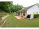 The backyard has a well-maintained lawn, brick patio, and mature trees at 2840 General Lee Way, Buford, GA 30519