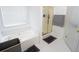 Bathroom with tiled shower, white walls, white tile, and white cabinets at 2840 General Lee Way, Buford, GA 30519