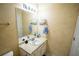 Bathroom with decorative yellow walls, vanity and sink with lighting above the mirror at 2840 General Lee Way, Buford, GA 30519