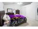 Bright bedroom with a ceiling fan, carpeted floors, and a decorative purple floral comforter at 2840 General Lee Way, Buford, GA 30519