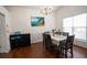 Inviting dining room with hardwood floors, bright window, and a stylish gold chandelier at 2840 General Lee Way, Buford, GA 30519