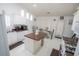 Bright kitchen featuring white cabinets, a center island, and tile flooring at 2840 General Lee Way, Buford, GA 30519