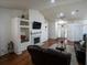 Open-concept living room with fireplace, hardwood floors, and ample seating at 2840 General Lee Way, Buford, GA 30519