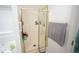 Bathroom featuring a glass-enclosed shower with gold trim at 2840 General Lee Way, Buford, GA 30519