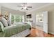 Bright bedroom with hardwood floors, ceiling fan, large window and attached bathroom at 3642 Princeton Ave, Atlanta, GA 30337