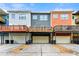 Rear view of townhomes with garages and decks on each unit at 3642 Princeton Ave, Atlanta, GA 30337