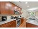 Kitchen featuring stainless steel appliances, wood cabinetry, and granite countertops at 3642 Princeton Ave, Atlanta, GA 30337