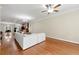 Open-concept living room with hardwood floors, ceiling fan, and seamless flow to the kitchen at 3642 Princeton Ave, Atlanta, GA 30337