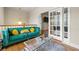 Upstairs living area featuring a velvet couch, glass table, and french doors to an adjacent bedroom at 3642 Princeton Ave, Atlanta, GA 30337