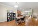 Open-concept space with dining area featuring modern chairs and a view into the cozy living room at 3642 Princeton Ave, Atlanta, GA 30337