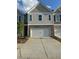 Two-story home featuring a brick facade and a two-car garage with a modern architectural design at 7621 Gray Pointe Dr, Lithonia, GA 30058