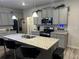 Modern kitchen with stainless steel appliances, gray cabinets, granite countertops, and a central island at 7621 Gray Pointe Dr, Lithonia, GA 30058