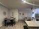 Open-concept living area featuring a dining table, contemporary decor, and hardwood flooring at 7621 Gray Pointe Dr, Lithonia, GA 30058